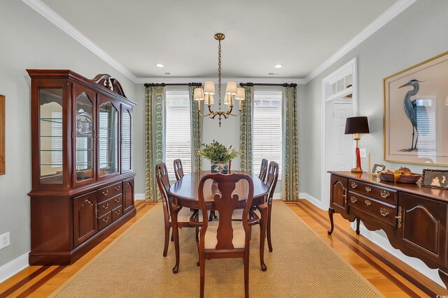 92 High Hammock Way, Pawleys Island, SC 29585 - dining room with a chandelier, light wood finished floors, crown molding, baseboards, and recessed lighting