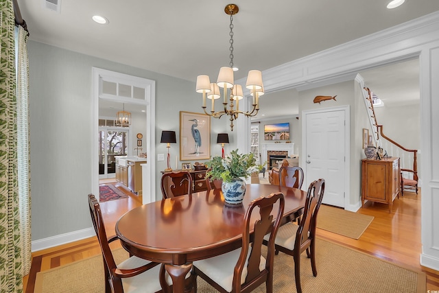 92 High Hammock Way, Pawleys Island, SC 29585 - dining area with a chandelier, light wood-style flooring, a brick fireplace, recessed lighting, and baseboards