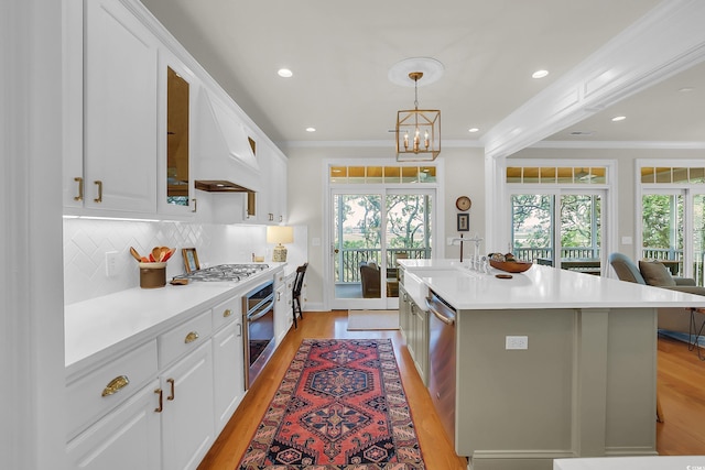 92 High Hammock Way, Pawleys Island, SC 29585 - kitchen featuring light wood-style floors, custom exhaust hood, healthy amount of natural light, white cabinets, and crown molding