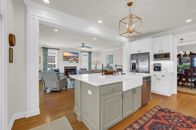 92 High Hammock Way, Pawleys Island, SC 29585 - kitchen featuring appliances with stainless steel finishes, a sink, light countertops, white cabinetry, and a chandelier