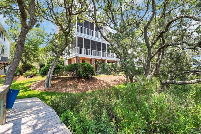 92 High Hammock Way, Pawleys Island, SC 29585 - back of house with a sunroom and a wooden deck