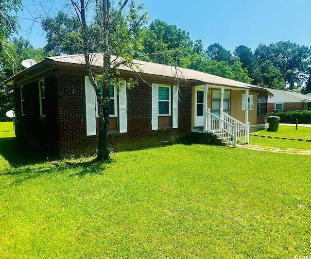 704 W Alder St, Andrews, SC 29510 - ranch-style home featuring brick siding, a front yard, and metal roof