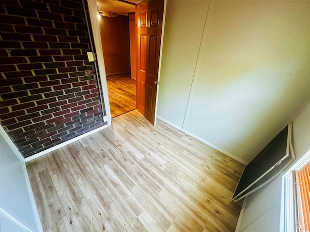 704 W Alder St, Andrews, SC 29510 - spare room with light wood finished floors, baseboards, and brick wall