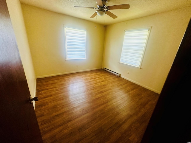 704 W Alder St, Andrews, SC 29510 - spare room featuring a baseboard radiator, wood finished floors, a ceiling fan, a textured ceiling, and baseboards