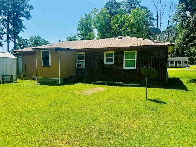704 W Alder St, Andrews, SC 29510 - back of house with a lawn, cooling unit, brick siding, and metal roof