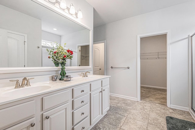 364 Palm Lakes Blvd, Little River, SC 29566 - full bathroom featuring double vanity, a walk in closet, baseboards, and a shower with door