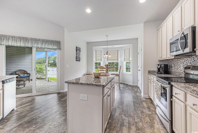 364 Palm Lakes Blvd, Little River, SC 29566 - kitchen featuring stainless steel appliances, baseboards, dark wood-type flooring, tasteful backsplash, and a center island