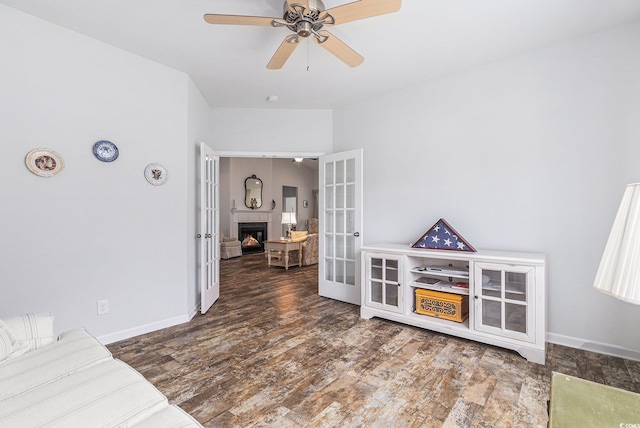 364 Palm Lakes Blvd, Little River, SC 29566 - interior space with a lit fireplace, french doors, a ceiling fan, wood finished floors, and baseboards