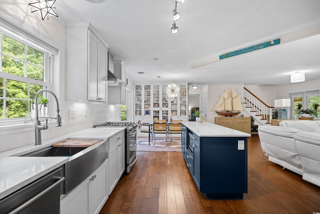 515 River Rd, Conway, SC 29526 - kitchen with appliances with stainless steel finishes, blue cabinetry, open floor plan, a sink, and tasteful backsplash