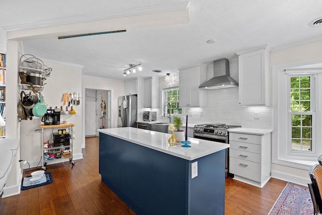 515 River Rd, Conway, SC 29526 - kitchen with wall chimney exhaust hood, appliances with stainless steel finishes, light countertops, dark wood finished floors, and backsplash