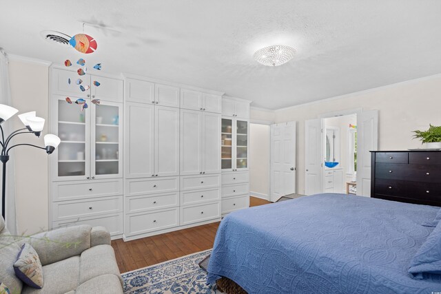 515 River Rd, Conway, SC 29526 - bedroom featuring dark wood-style flooring, crown molding, connected bathroom, and a textured ceiling