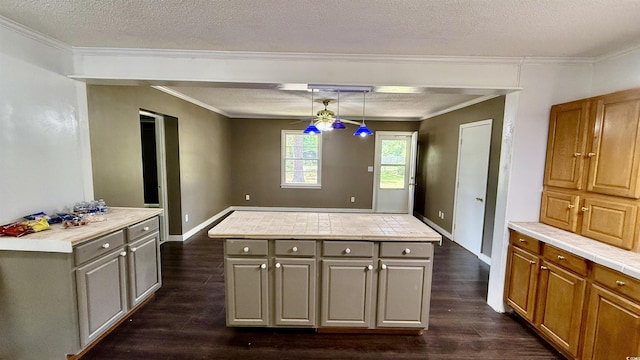 6805 Mclaurin Rd, Mullins, SC 29574 - kitchen with dark wood-style flooring, ornamental molding, light countertops, gray cabinetry, and a kitchen island