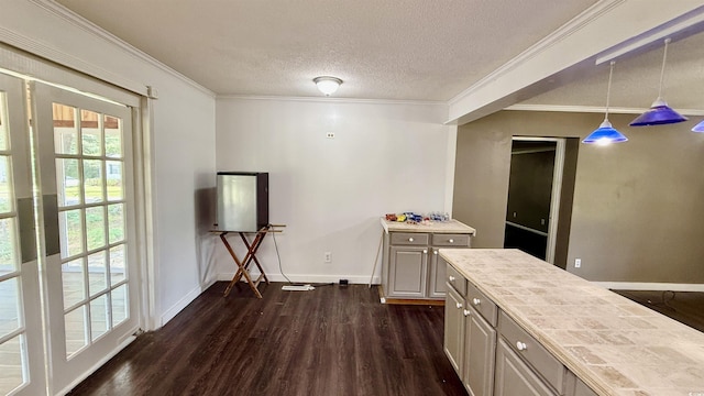 6805 Mclaurin Rd, Mullins, SC 29574 - kitchen with dark wood-style flooring, crown molding, light countertops, hanging light fixtures, and a textured ceiling