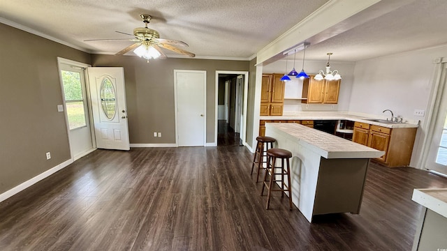 6805 Mclaurin Rd, Mullins, SC 29574 - kitchen with light countertops, dark wood-style flooring, a breakfast bar, a textured ceiling, and a ceiling fan