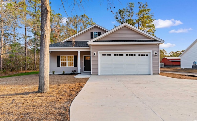 146 Temple Dr, Aynor, SC 29511 - traditional home featuring concrete driveway, an attached garage, covered porch, and roof with shingles