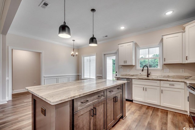 142 Temple Dr, Aynor, SC 29511 - kitchen with a sink, stainless steel appliances, light wood-style floors, white cabinets, and ornamental molding