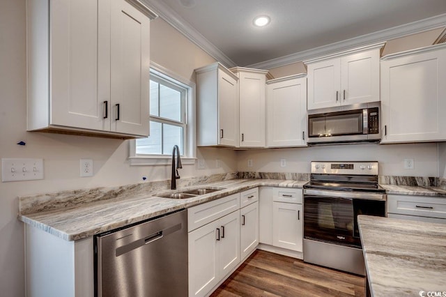 142 Temple Dr, Aynor, SC 29511 - kitchen featuring stainless steel appliances, a sink, crown molding, white cabinets, and dark wood-style flooring