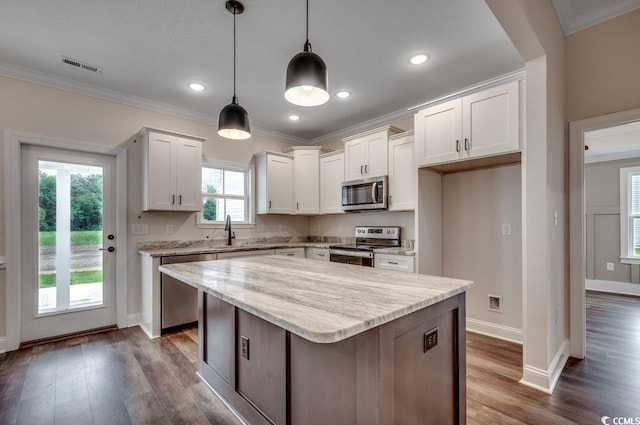 142 Temple Dr, Aynor, SC 29511 - kitchen featuring appliances with stainless steel finishes, crown molding, baseboards, white cabinetry, and dark wood-style floors