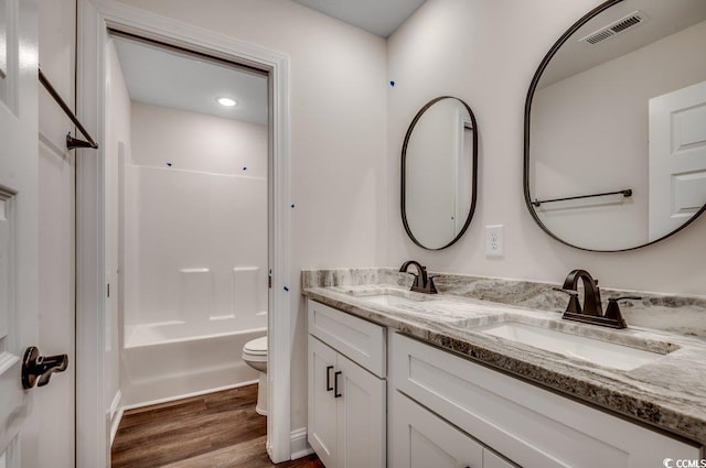 142 Temple Dr, Aynor, SC 29511 - bathroom featuring toilet, double vanity, wood finished floors, and bathtub / shower combination
