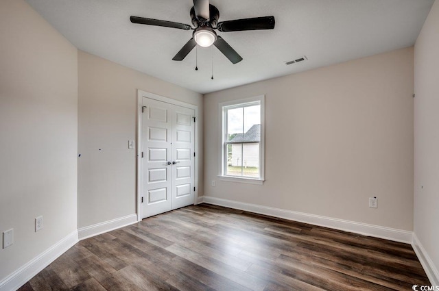 142 Temple Dr, Aynor, SC 29511 - unfurnished bedroom featuring dark wood finished floors, baseboards, and a ceiling fan