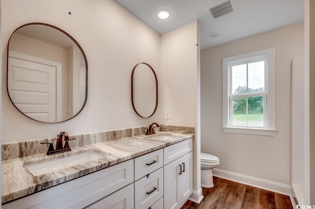 142 Temple Dr, Aynor, SC 29511 - bathroom with baseboards, double vanity, toilet, and wood finished floors