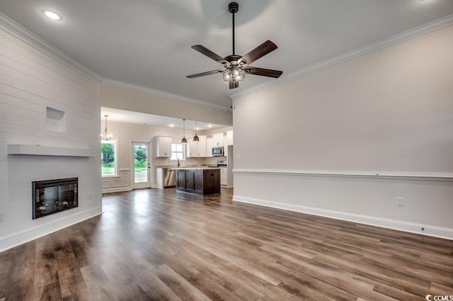 142 Temple Dr, Aynor, SC 29511 - unfurnished living room featuring crown molding, ceiling fan, dark wood-style floors, baseboards, and a large fireplace