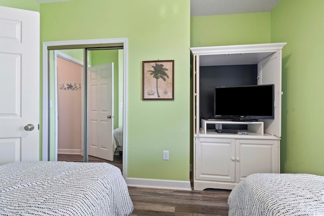 5801 Oyster Catcher Dr Unit 332, North Myrtle Beach, SC 29582 - bedroom featuring dark wood-style flooring, baseboards, and a closet