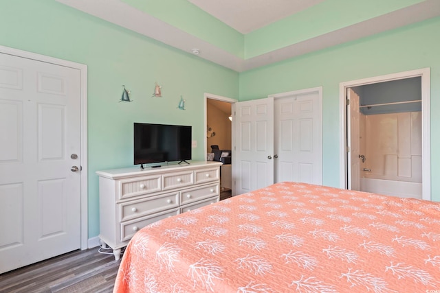 5801 Oyster Catcher Dr Unit 332, North Myrtle Beach, SC 29582 - bedroom featuring wood finished floors, connected bathroom, and baseboards