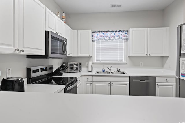 5801 Oyster Catcher Dr Unit 332, North Myrtle Beach, SC 29582 - kitchen with stainless steel appliances, a sink, and white cabinets