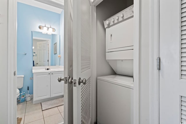 5801 Oyster Catcher Dr Unit 332, North Myrtle Beach, SC 29582 - washroom with stacked washer / dryer and light tile patterned flooring