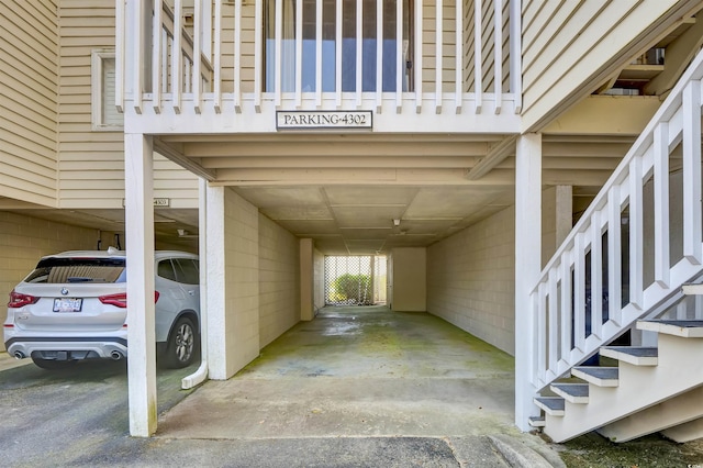 1912 Goose Creek Rd SW Unit 4302, Ocean Isle Beach, NC 28469 - view of parking / parking lot featuring a carport and stairway