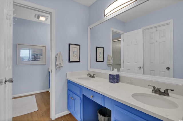 1912 Goose Creek Rd SW Unit 4302, Ocean Isle Beach, NC 28469 - bathroom featuring wood finished floors, double vanity, baseboards, and a shower