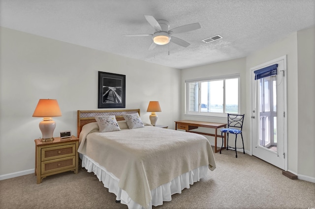 1912 Goose Creek Rd SW Unit 4302, Ocean Isle Beach, NC 28469 - bedroom with carpet, baseboards, access to exterior, a textured ceiling, and a ceiling fan