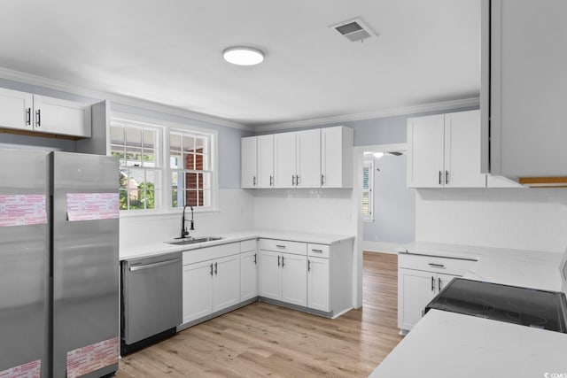 401 S Nichols St, Nichols, SC 29581 - kitchen featuring stainless steel appliances, a sink, white cabinetry, decorative backsplash, and ornamental molding