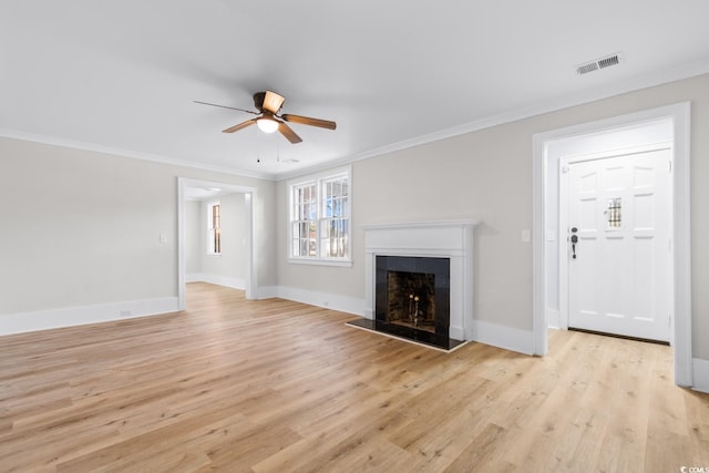 401 S Nichols St, Nichols, SC 29581 - unfurnished living room featuring a ceiling fan, light wood finished floors, ornamental molding, a fireplace with raised hearth, and baseboards