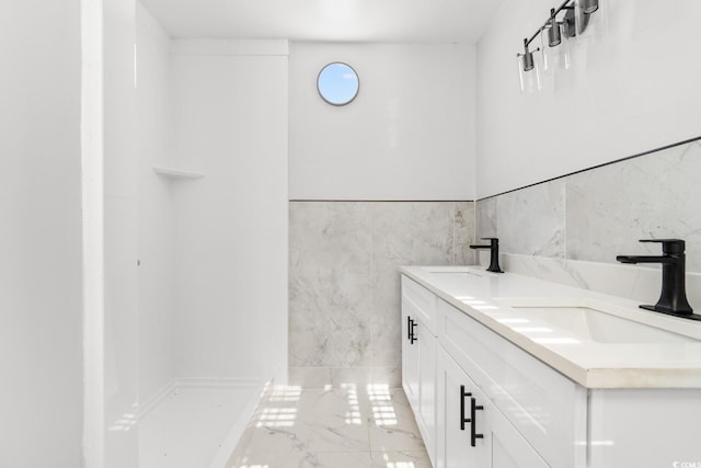 401 S Nichols St, Nichols, SC 29581 - full bathroom featuring marble tiled floors, tile walls, double vanity, and a wainscoted wall