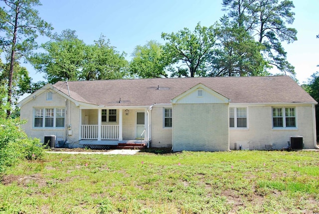 401 S Nichols St, Nichols, SC 29581 - view of front facade featuring central air condition unit, covered porch, brick siding, and a front yard