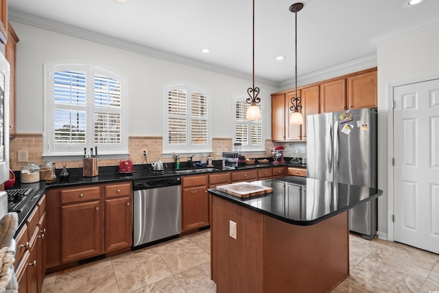 861 Murray Ave, Myrtle Beach, SC 29577 - kitchen with appliances with stainless steel finishes, healthy amount of natural light, a sink, ornamental molding, and brown cabinets