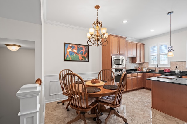 861 Murray Ave, Myrtle Beach, SC 29577 - dining space featuring ornamental molding, a chandelier, and wainscoting