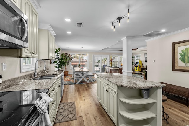 1616 S Ocean Blvd, North Myrtle Beach, SC 29582 - kitchen featuring stainless steel microwave, a sink, crown molding, light wood finished floors, and light stone countertops