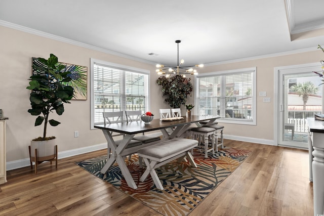1616 S Ocean Blvd, North Myrtle Beach, SC 29582 - dining area with ornamental molding, healthy amount of natural light, light wood-style floors, a chandelier, and baseboards