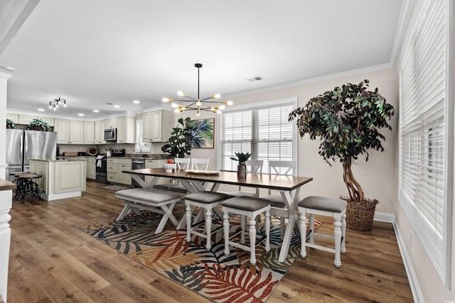 1616 S Ocean Blvd, North Myrtle Beach, SC 29582 - dining space featuring ornamental molding, a chandelier, wood finished floors, baseboards, and recessed lighting