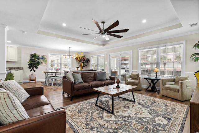 1616 S Ocean Blvd, North Myrtle Beach, SC 29582 - living area with a raised ceiling, a ceiling fan, ornamental molding, wood finished floors, and a chandelier