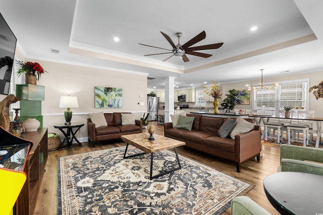 1616 S Ocean Blvd, North Myrtle Beach, SC 29582 - living area with a tray ceiling, a ceiling fan, light wood-style floors, crown molding, and recessed lighting
