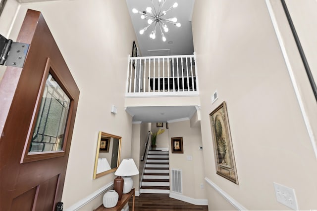 1616 S Ocean Blvd, North Myrtle Beach, SC 29582 - foyer entrance with a towering ceiling, stairs, a chandelier, wood finished floors, and baseboards