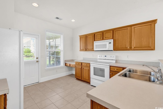 101 Culpepper Way Unit 1006, Myrtle Beach, SC 29579 - kitchen with white appliances, a sink, light tile patterned floors, light countertops, and brown cabinetry