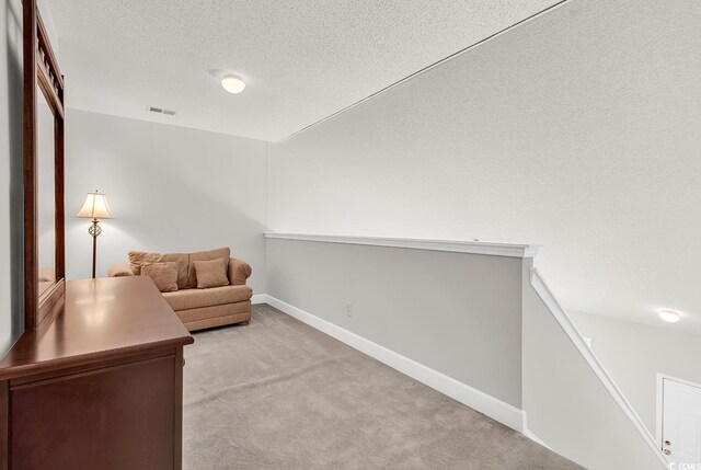 101 Culpepper Way Unit 1006, Myrtle Beach, SC 29579 - sitting room with light colored carpet, a textured ceiling, baseboards, and lofted ceiling