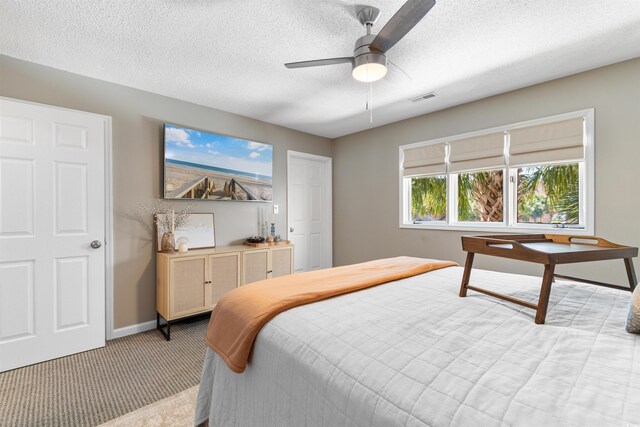 210 Double Eagle Dr Unit B-2, Surfside Beach, SC 29575 - bedroom with light colored carpet, baseboards, a textured ceiling, and a ceiling fan