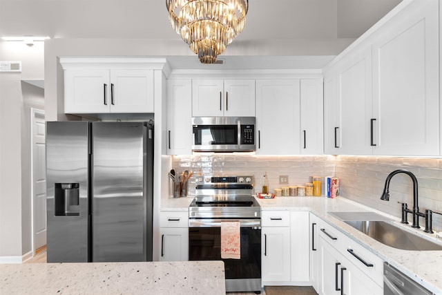 210 Double Eagle Dr Unit B-2, Surfside Beach, SC 29575 - kitchen featuring appliances with stainless steel finishes, a sink, light stone countertops, and decorative backsplash