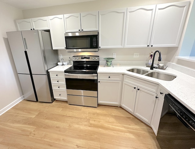 107 Pawleys Place Dr Unit 107, Pawleys Island, SC 29585 - kitchen featuring appliances with stainless steel finishes, a sink, white cabinetry, and light wood finished floors